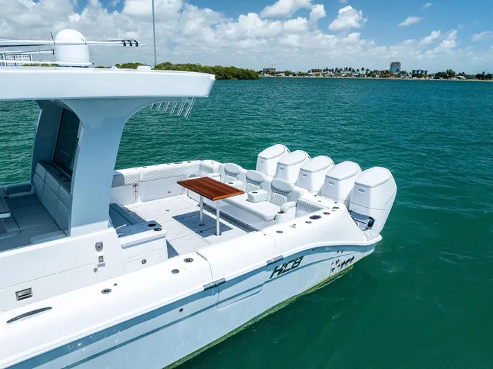  Yacht Photos Pics 2025 HCB 56' Sueños GIX luxury boat on clear blue water, featuring multiple engines.