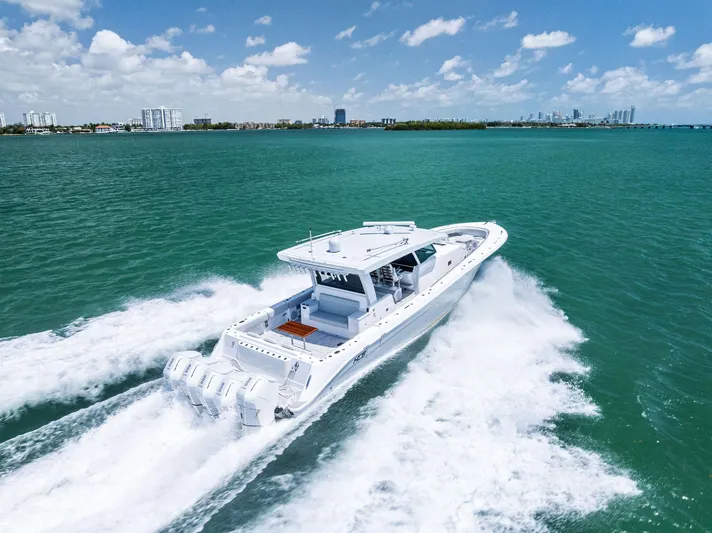  Yacht Photos Pics 2025 HCB 56' Sueños GIX cruising on turquoise waters under a clear blue sky.