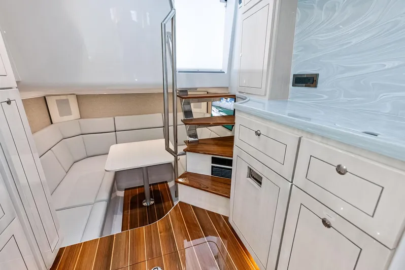  Yacht Photos Pics Luxurious interior of 2025 HCB 56' Sueños GIX yacht with elegant seating and wooden flooring.