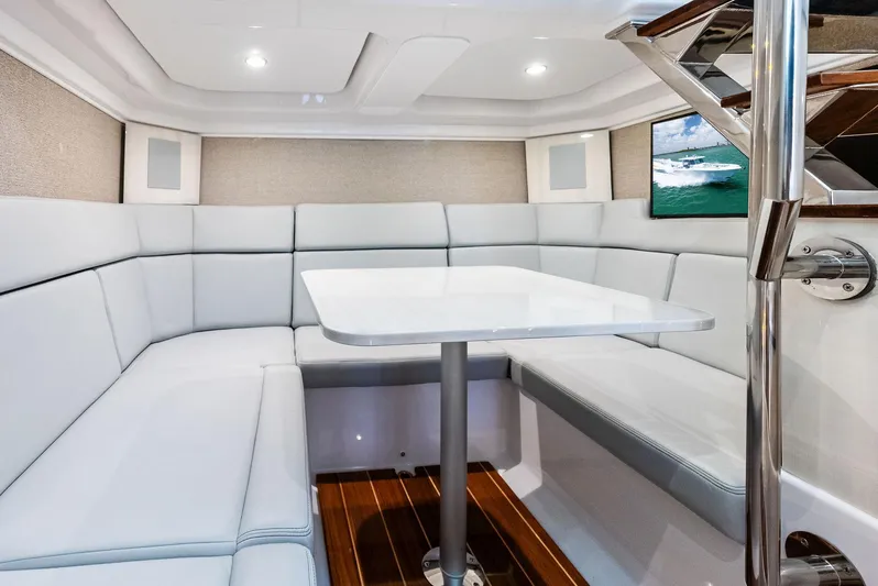  Yacht Photos Pics Luxurious interior of 2025 HCB 56' Sueños GIX yacht with modern seating and table.