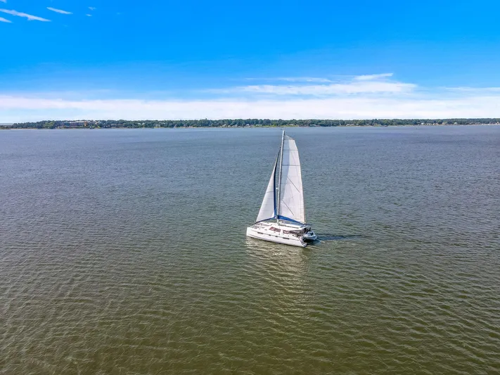 Vlaroda Yacht Photos Pics Sailing catamaran Nautitech 46 Open, 2017 model, on open water under clear blue sky.