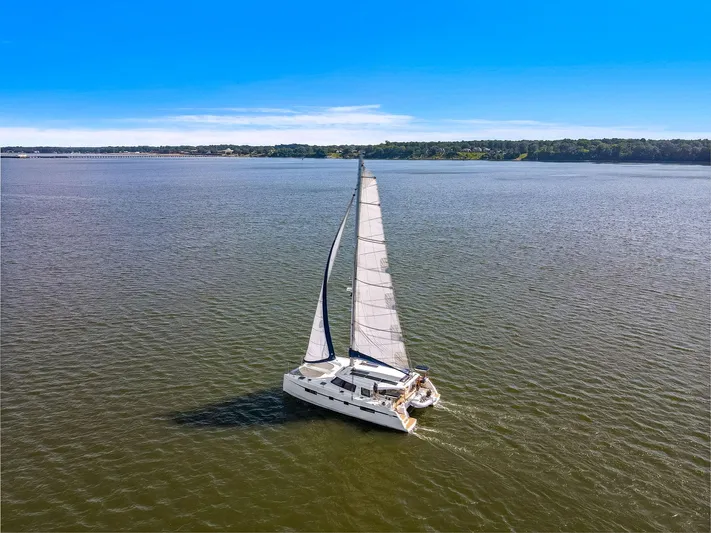 Vlaroda Yacht Photos Pics Sailing catamaran Nautitech 46 Open, 2017 model, cruising on open water under clear blue skies.