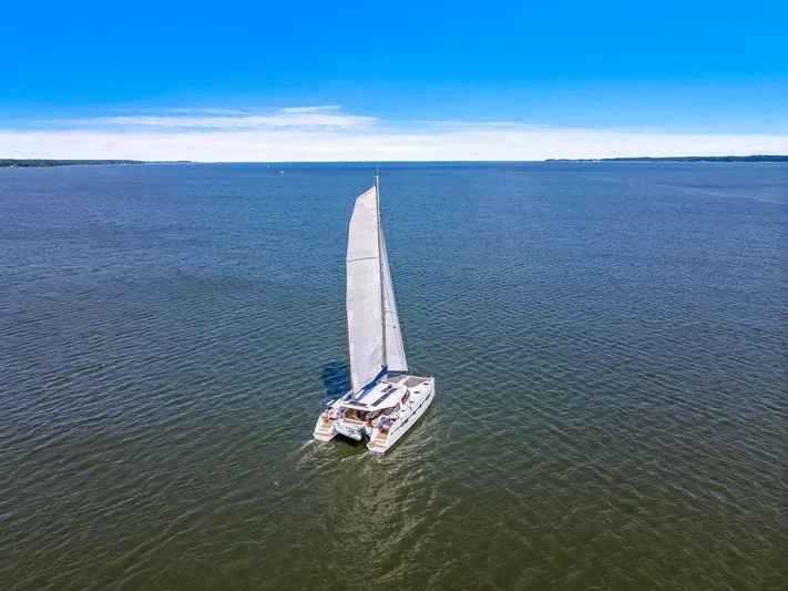 Vlaroda Yacht Photos Pics Sailing catamaran Nautitech 46 Open 2017 on open sea under clear blue sky.