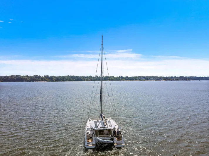Vlaroda Yacht Photos Pics 2017 Nautitech 46 Open catamaran sailing on a calm lake under a clear blue sky.