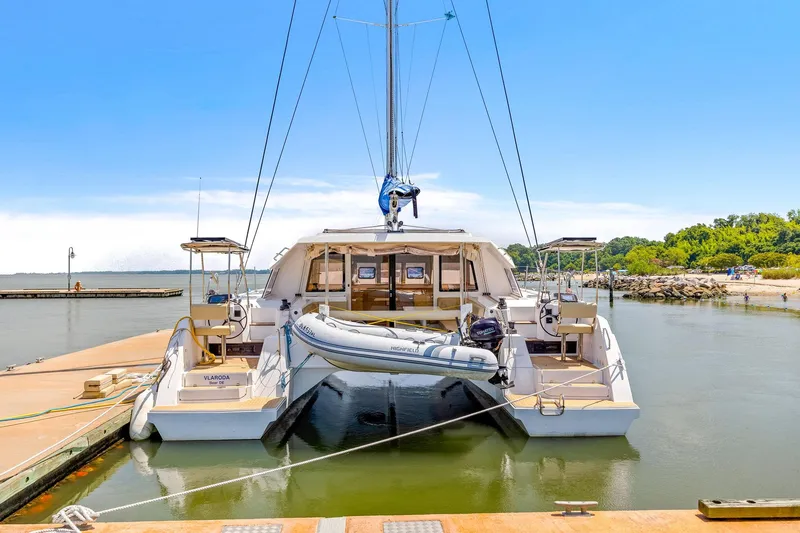 Vlaroda Yacht Photos Pics 2017 Nautitech 46 Open catamaran docked, featuring spacious deck and inflatable dinghy.