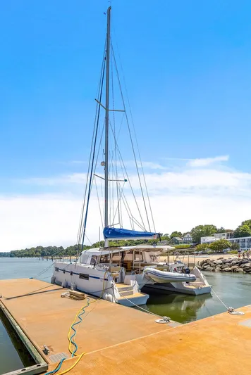 Vlaroda Yacht Photos Pics 2017 Nautitech 46 Open catamaran docked at a marina under a clear blue sky.