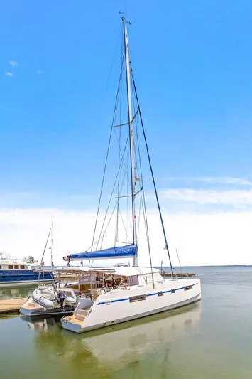 Vlaroda Yacht Photos Pics 2017 Nautitech 46 Open catamaran docked, featuring sleek design and spacious deck under clear blue sky.