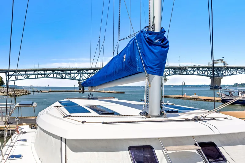 Vlaroda Yacht Photos Pics 2017 Nautitech 46 Open catamaran docked near a bridge, featuring a blue sail cover.