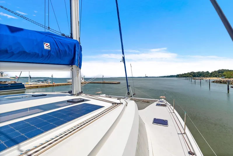 Vlaroda Yacht Photos Pics Nautitech 46 Open 2017 catamaran sailing on a calm river under a clear blue sky.