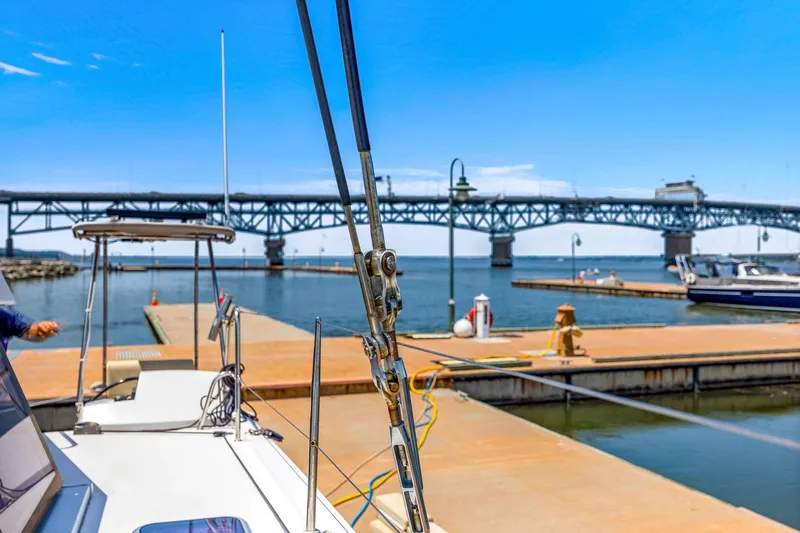 Vlaroda Yacht Photos Pics Nautitech 46 Open 2017 catamaran docked near a bridge on a sunny day.
