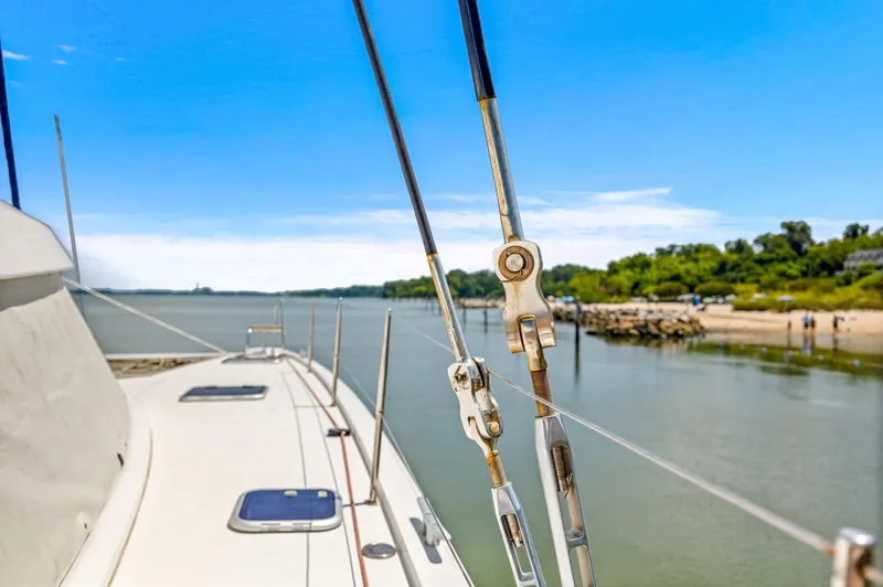 Vlaroda Yacht Photos Pics Nautitech 46 Open 2017 catamaran sailing near a scenic shoreline under a clear blue sky.