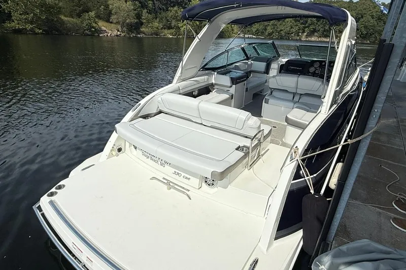  Yacht Photos Pics 2018 Formula 330 Crossover Bowrider docked on a serene lake.