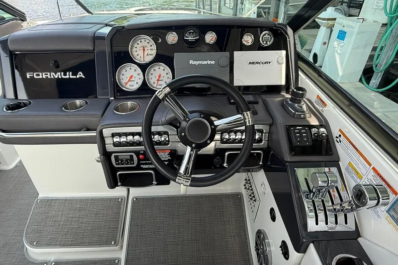  Yacht Photos Pics Cockpit of 2018 Formula 330 Crossover Bowrider with steering wheel and control panel.