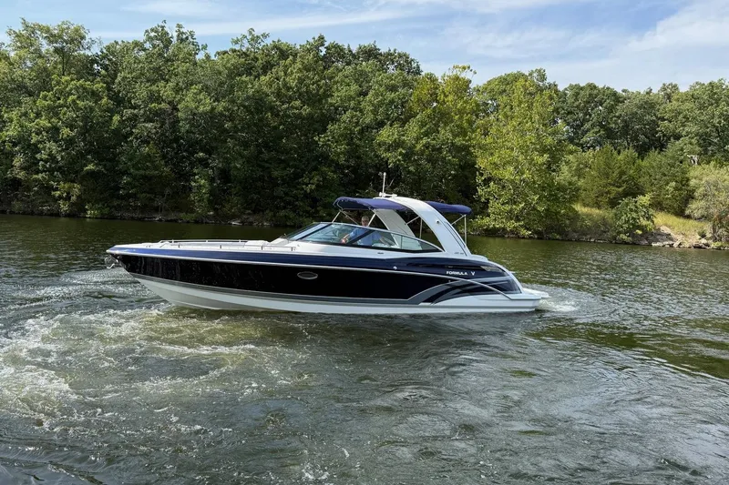  Yacht Photos Pics 2018 Formula 330 Crossover Bowrider cruising on a scenic lake with lush greenery.