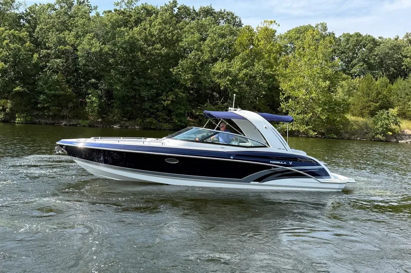  Yacht Photos Pics 2018 Formula 330 Crossover Bowrider cruising on a scenic lake with lush greenery.