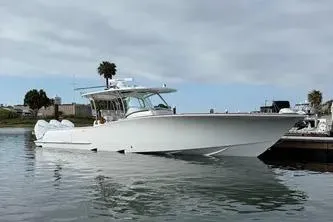  Yacht Photos Pics 2026 Mag Bay 38 CC boat docked on calm water under cloudy sky.