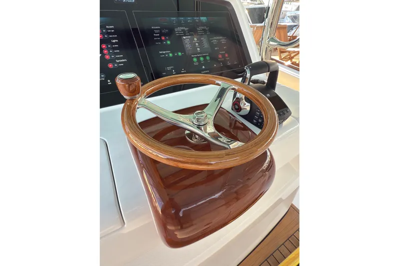  Yacht Photos Pics Steering wheel and controls of 2026 Mag Bay 38 CC boat, featuring modern dashboard.