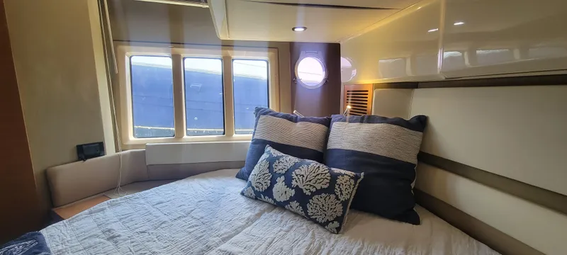 Yacht Photos Pics Luxurious bedroom interior of 2013 Azimut 45 Flybridge yacht with cozy bedding and ample natural light.