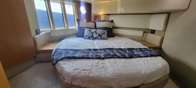  Yacht Photos Pics Luxurious bedroom interior of 2013 Azimut 45 Flybridge yacht with large bed and windows.
