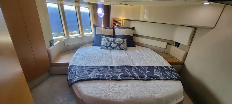  Yacht Photos Pics Luxurious bedroom in 2013 Azimut 45 Flybridge yacht with large windows and elegant bedding.