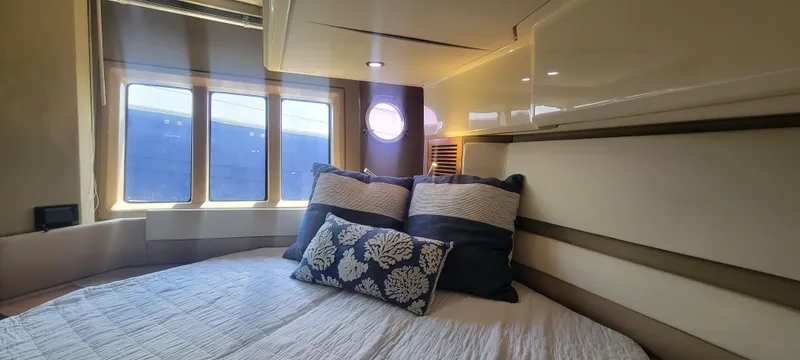  Yacht Photos Pics Luxurious bedroom interior of 2013 Azimut 45 Flybridge yacht with large windows.