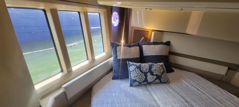 Yacht Photos Pics Luxurious bedroom interior of 2013 Azimut 45 Flybridge yacht with large windows and plush pillows.