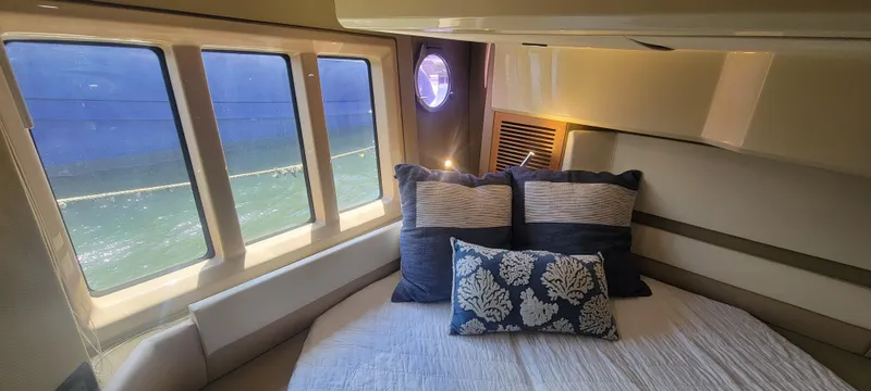  Yacht Photos Pics Luxurious bedroom interior of 2013 Azimut 45 Flybridge yacht with ocean view windows.