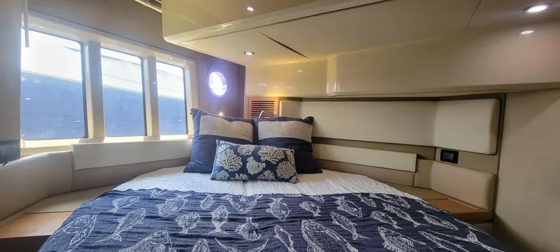  Yacht Photos Pics Luxurious bedroom interior of 2013 Azimut 45 Flybridge yacht with large windows.