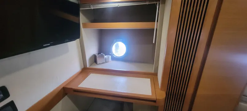  Yacht Photos Pics Interior cabin of 2013 Azimut 45 Flybridge yacht with desk and porthole.