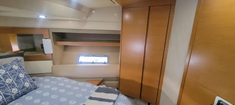  Yacht Photos Pics Luxurious bedroom interior of 2013 Azimut 45 Flybridge yacht with wooden cabinetry.