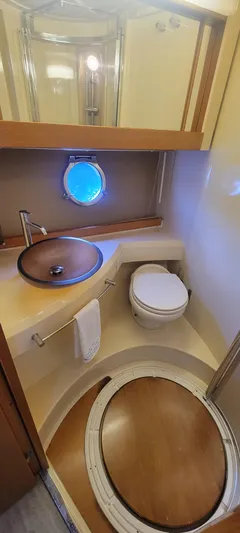  Yacht Photos Pics 2013 Azimut 45 Flybridge yacht bathroom with modern fixtures and porthole window.