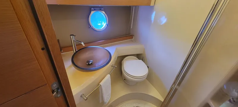  Yacht Photos Pics 2013 Azimut 45 Flybridge bathroom with modern sink and porthole window.