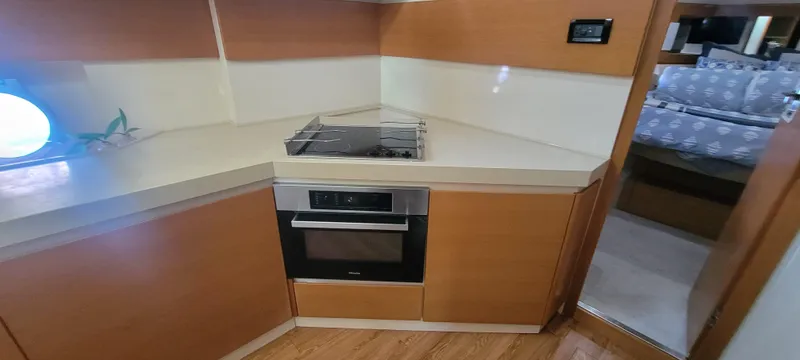  Yacht Photos Pics 2013 Azimut 45 Flybridge kitchen with modern appliances and wooden cabinetry.