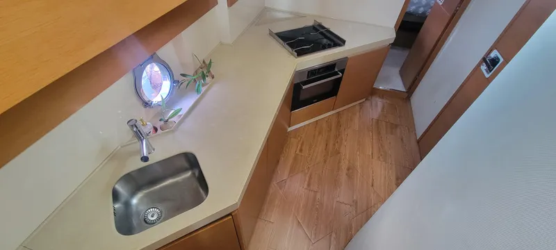  Yacht Photos Pics Modern kitchen area in 2013 Azimut 45 Flybridge yacht with sink and stove.