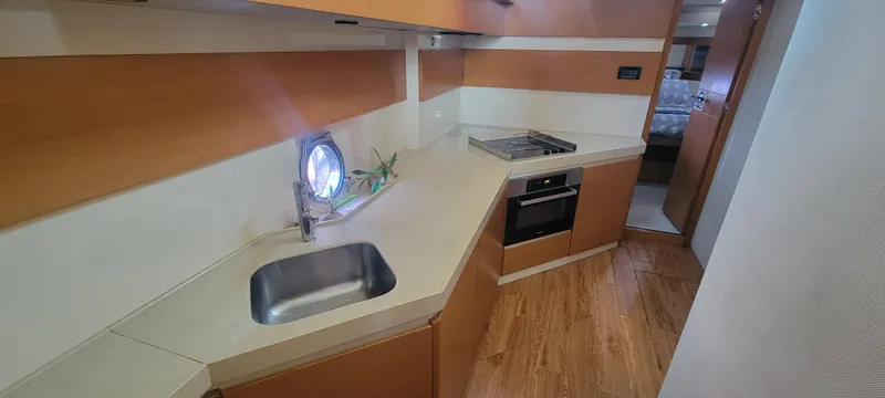  Yacht Photos Pics 2013 Azimut 45 Flybridge yacht kitchen with modern appliances and wood flooring.