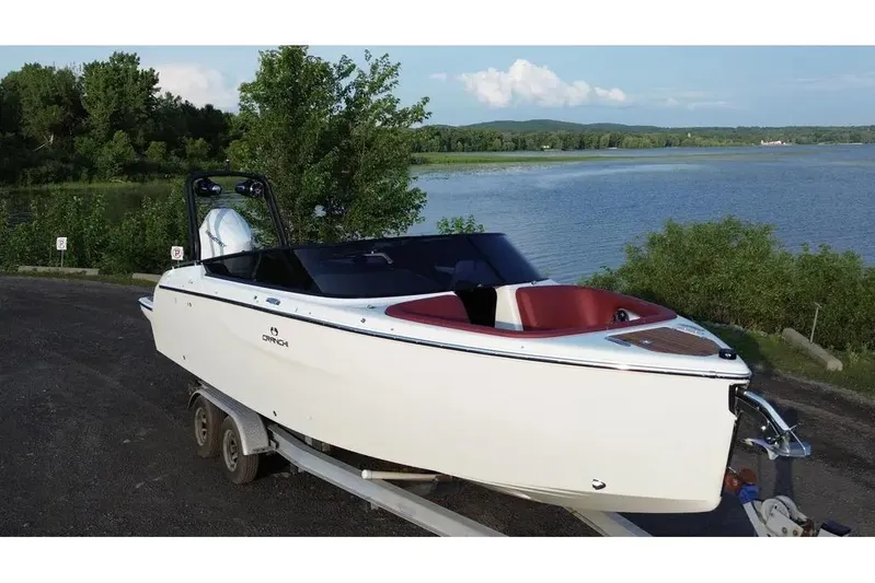  Yacht Photos Pics 2024 Cranchi E26 Classic boat on trailer by a scenic lake.