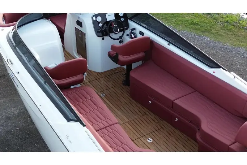  Yacht Photos Pics 2024 Cranchi E26 Classic boat interior with red seating and wooden flooring.