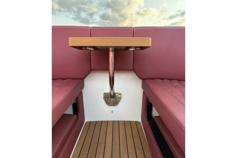  Yacht Photos Pics 2024 Cranchi E26 Classic interior with red seating and wooden table.