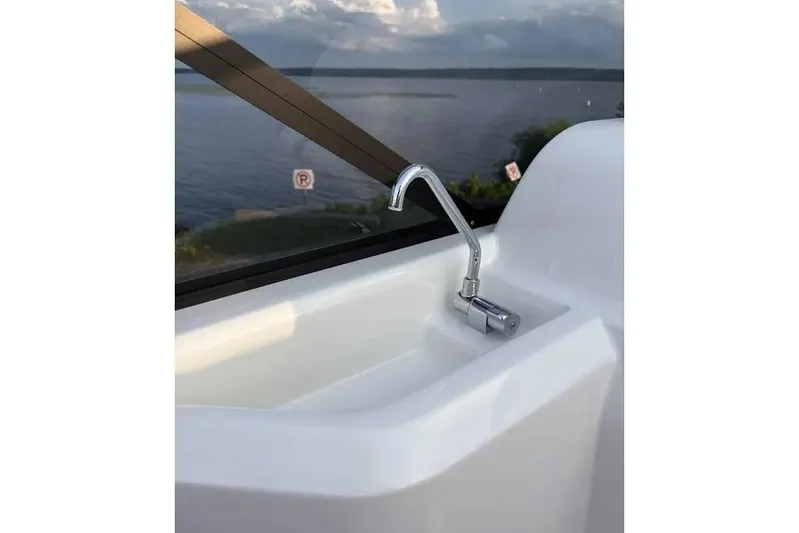  Yacht Photos Pics Chrome faucet on 2024 Cranchi E26 Classic boat with scenic water view.