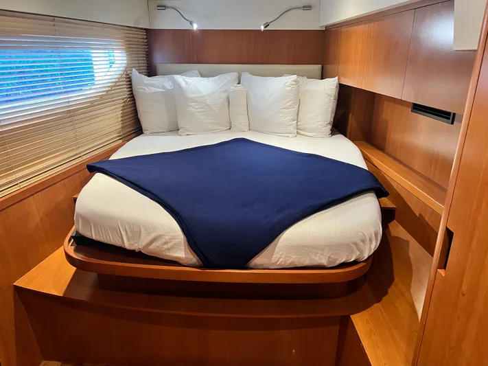  Yacht Photos Pics Luxurious cabin interior of 2016 Aquila 48 yacht with cozy bed and wooden finish.