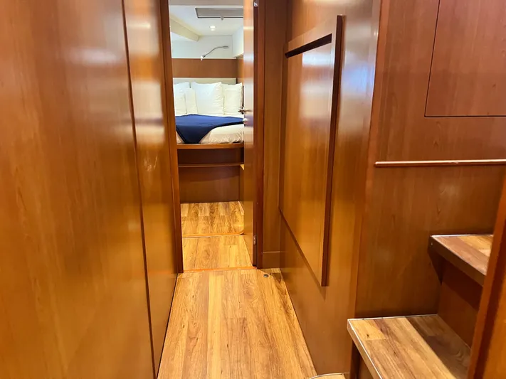  Yacht Photos Pics Interior of 2016 Aquila 48 yacht with wooden flooring and cozy bedroom.