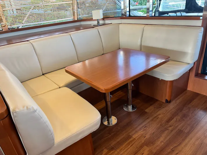  Yacht Photos Pics Luxurious interior of 2016 Aquila 48 yacht with elegant seating and wooden table.