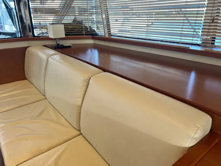  Yacht Photos Pics Luxurious interior of 2016 Aquila 48 yacht with cream leather seating and wooden accents.