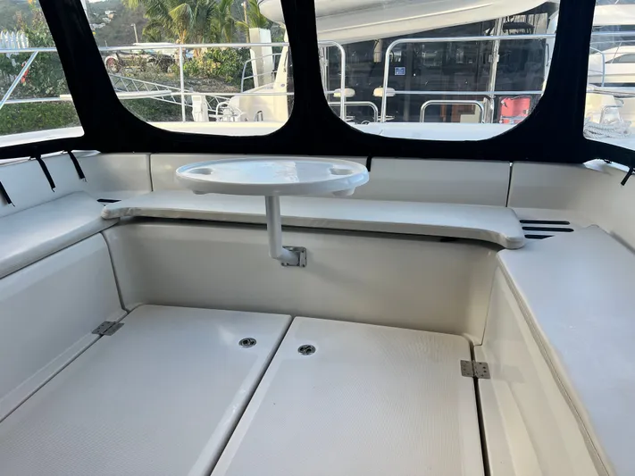  Yacht Photos Pics Interior seating area of a 2016 Aquila 48 yacht with a small table.