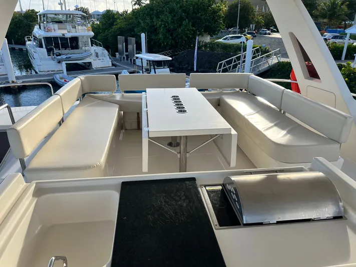  Yacht Photos Pics Luxurious seating area on 2016 Aquila 48 yacht with table and grill.