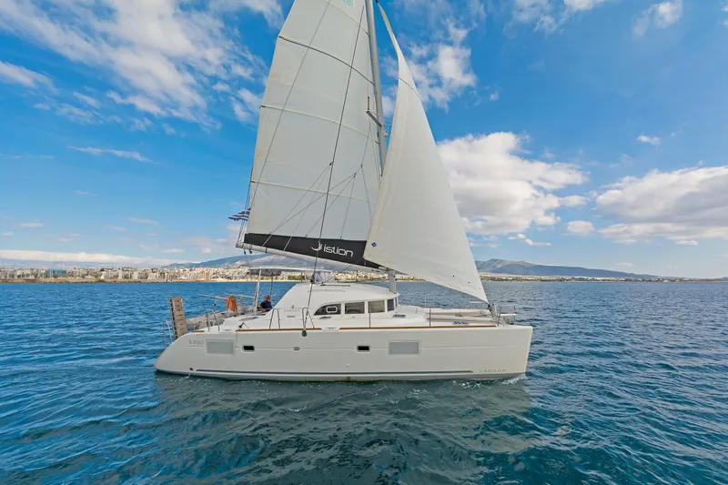  Yacht Photos Pics 2017 Lagoon 380 S2 catamaran sailing on open water under a clear blue sky.