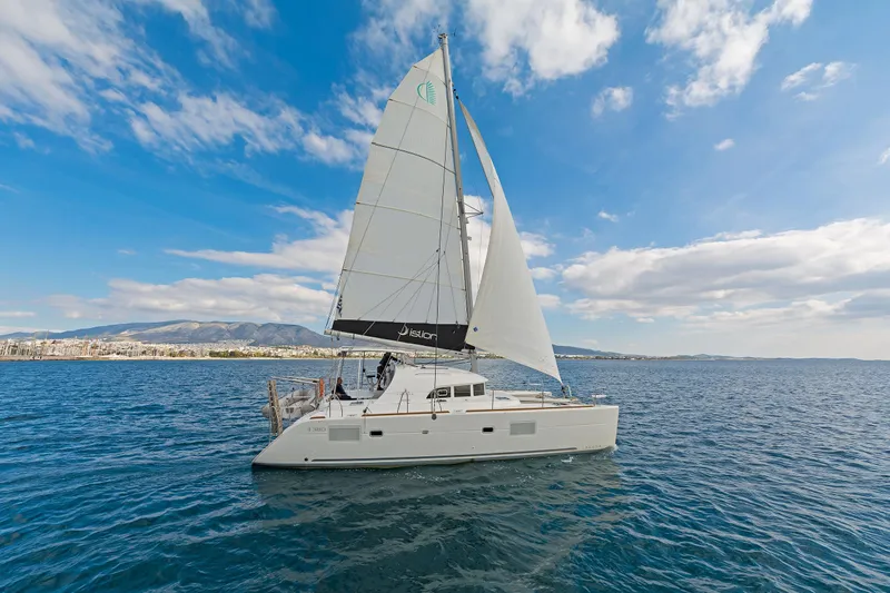  Yacht Photos Pics 2017 Lagoon 380 S2 catamaran sailing on open sea under clear blue sky.