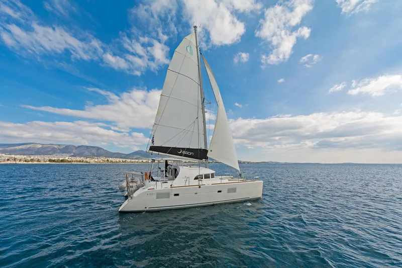  Yacht Photos Pics Sailing catamaran Lagoon 380 S2, 2017 model, cruising on open sea under blue sky.