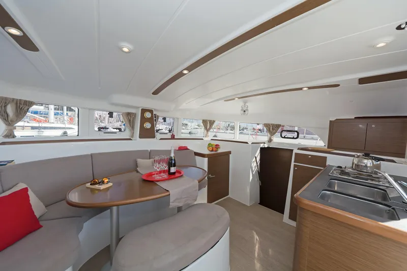  Yacht Photos Pics Interior of 2017 Lagoon 380 S2 catamaran with modern kitchen and cozy seating area.