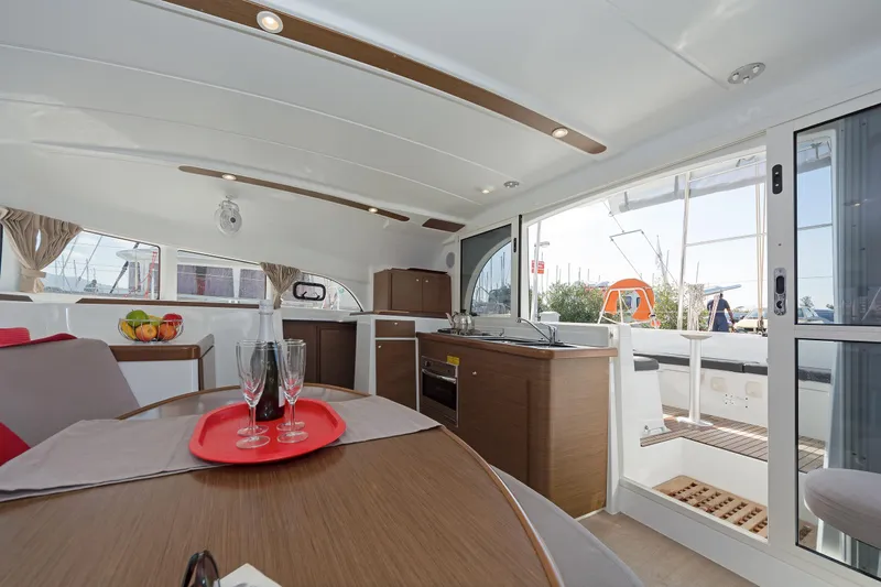  Yacht Photos Pics Interior of 2017 Lagoon 380 S2 catamaran with modern kitchen and dining area.